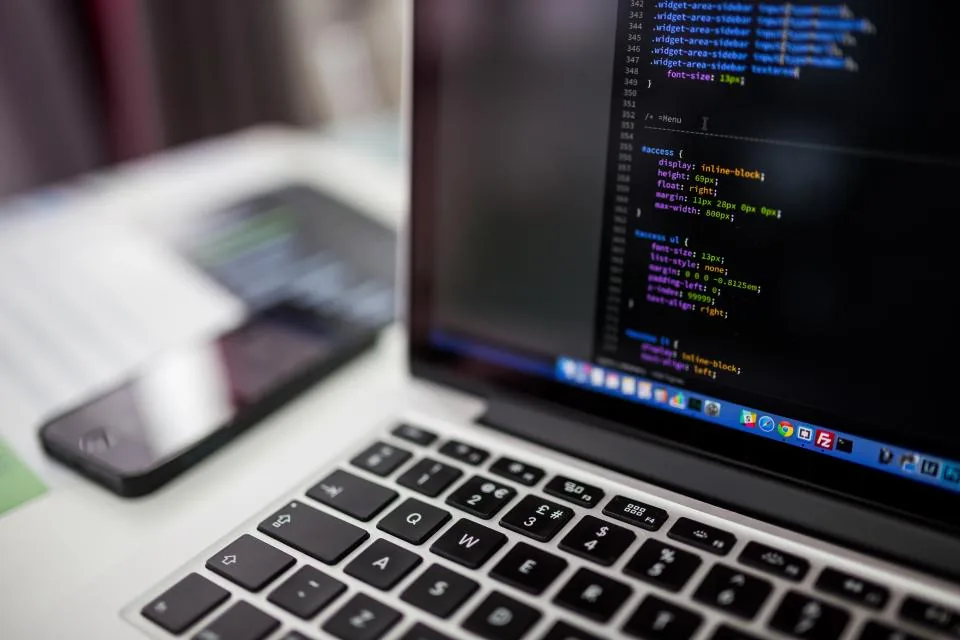 Laptop showing code for an AI agent platform