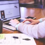 Customer support representative with a headset working alongside AI agents