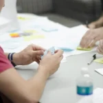 Small team collaborating around a laptop while planning workflow automation with AI agents